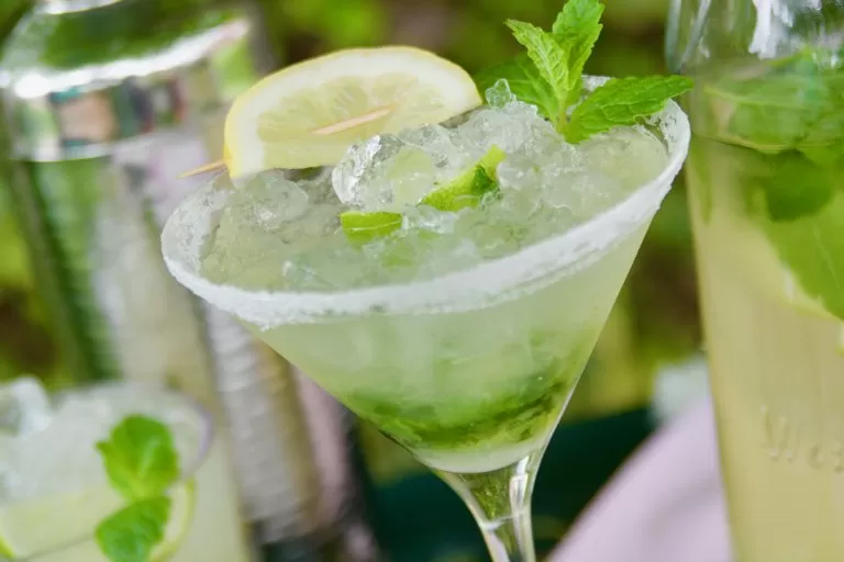 Fresh mojito mocktail with garnish of mint leaves, ice, and sliced lime